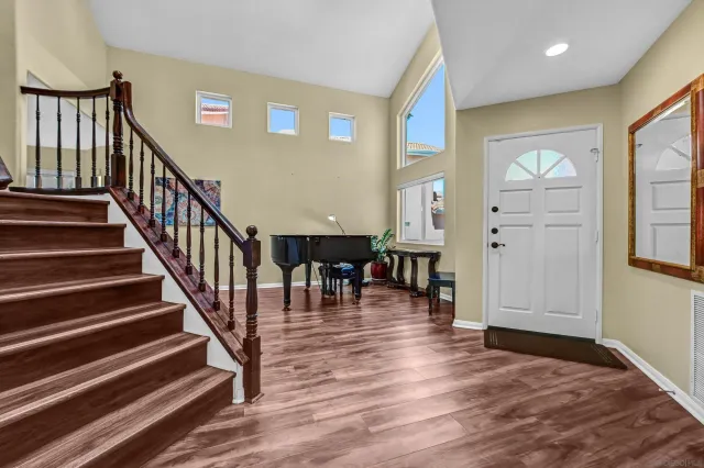 a view of entryway and hall with wooden floor