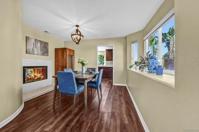 a view of a dining room with furniture a chandelier and wooden floor
