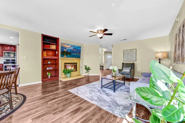 a living room with furniture a window and a flat screen tv