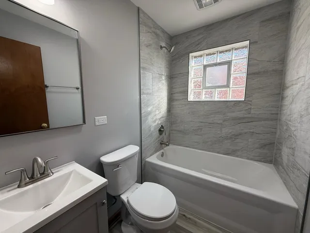a bathroom with a sink toilet and bathtub
