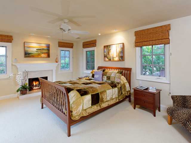 1316 Crest Road Del Mar, CA 92014 - Photo 11 of 25 The generous master suite boasts French doors out to the deck and back yard, a wonderful fireplace, and room for a private sitting area.
