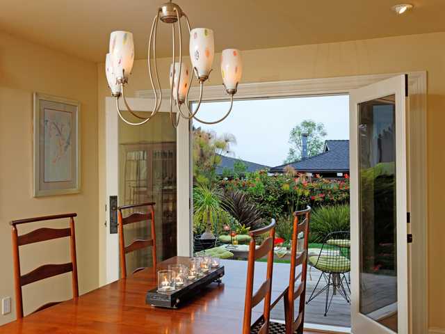 1316 Crest Road Del Mar, CA 92014 - Photo 10 of 25 More beautiful detailing in the dining room including playful light fixture and large French doors out to deck and yard.