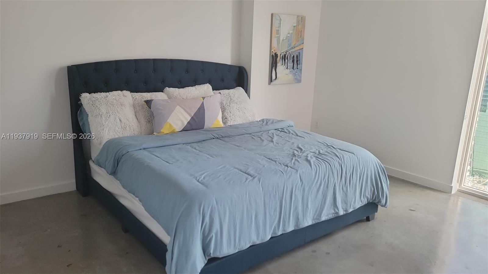 151 Southeast 1st Street, Unit 2507 Miami, FL 33131 - Photo 24 of 34 a bed sitting in a bedroom next to a window