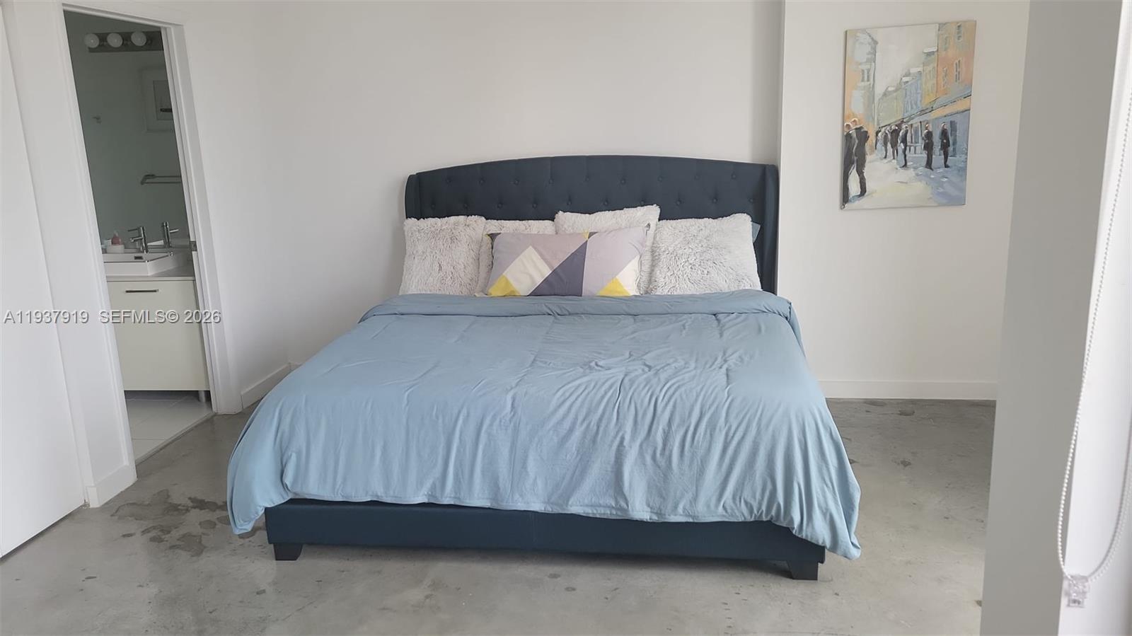 151 Southeast 1st Street, Unit 2507 Miami, FL 33131 - Photo 25 of 34 a bedroom with a bed and painting on the wall