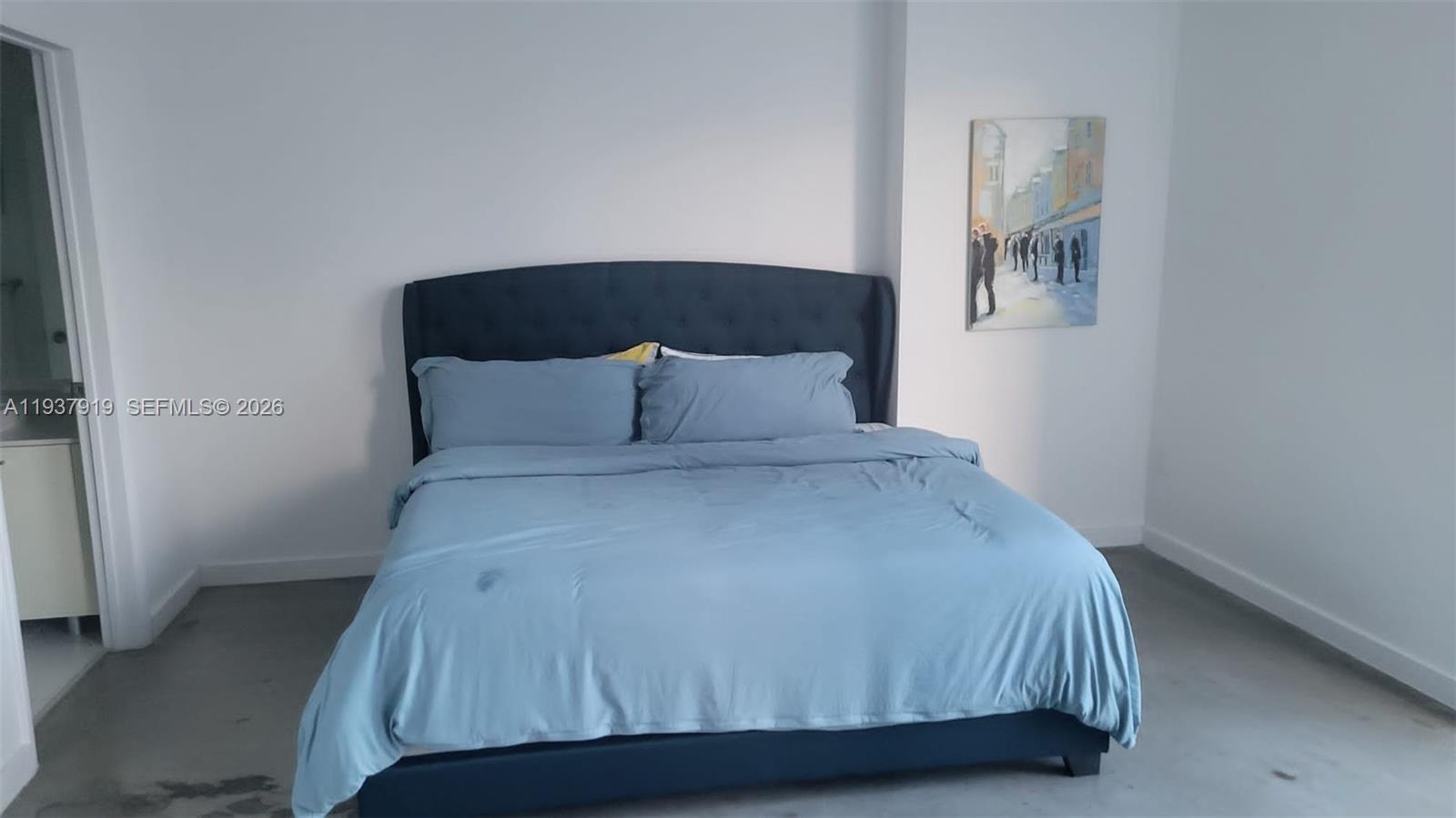 151 Southeast 1st Street, Unit 2507 Miami, FL 33131 - Photo 28 of 34 a bedroom with a bed and painting on the wall