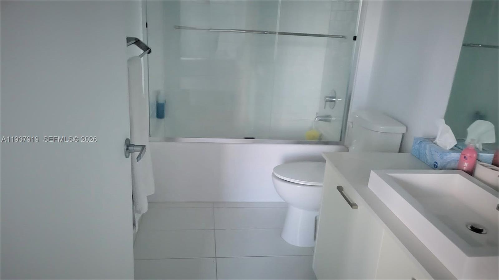 151 Southeast 1st Street, Unit 2507 Miami, FL 33131 - Photo 6 of 34 a bathroom with a sink a toilet and shower