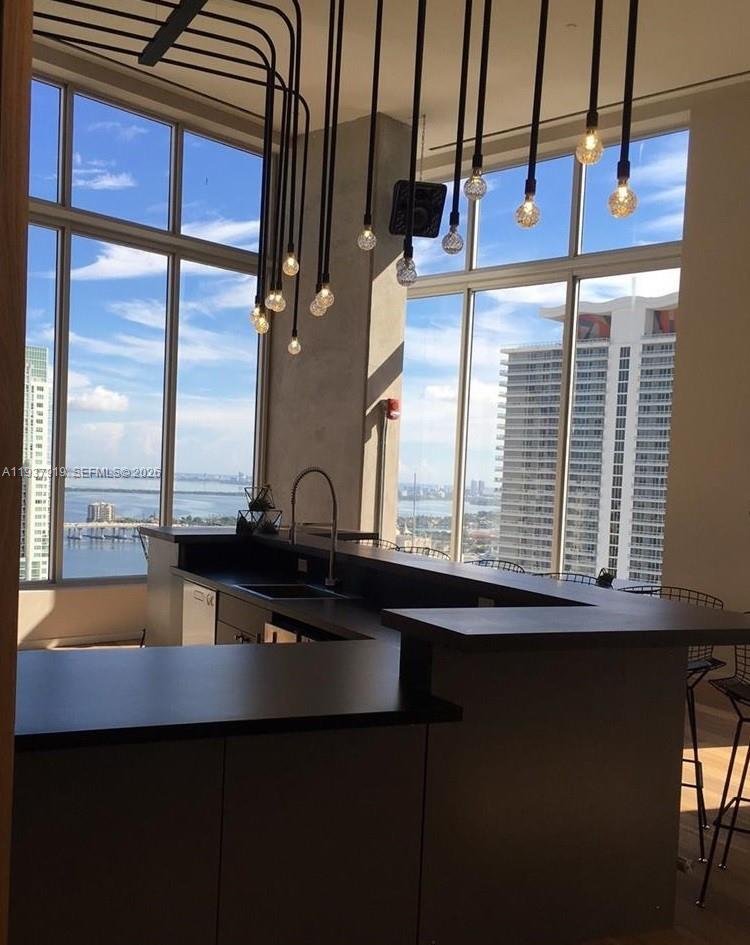 151 Southeast 1st Street, Unit 2507 Miami, FL 33131 - Photo 8 of 34 a kitchen with a sink and a window