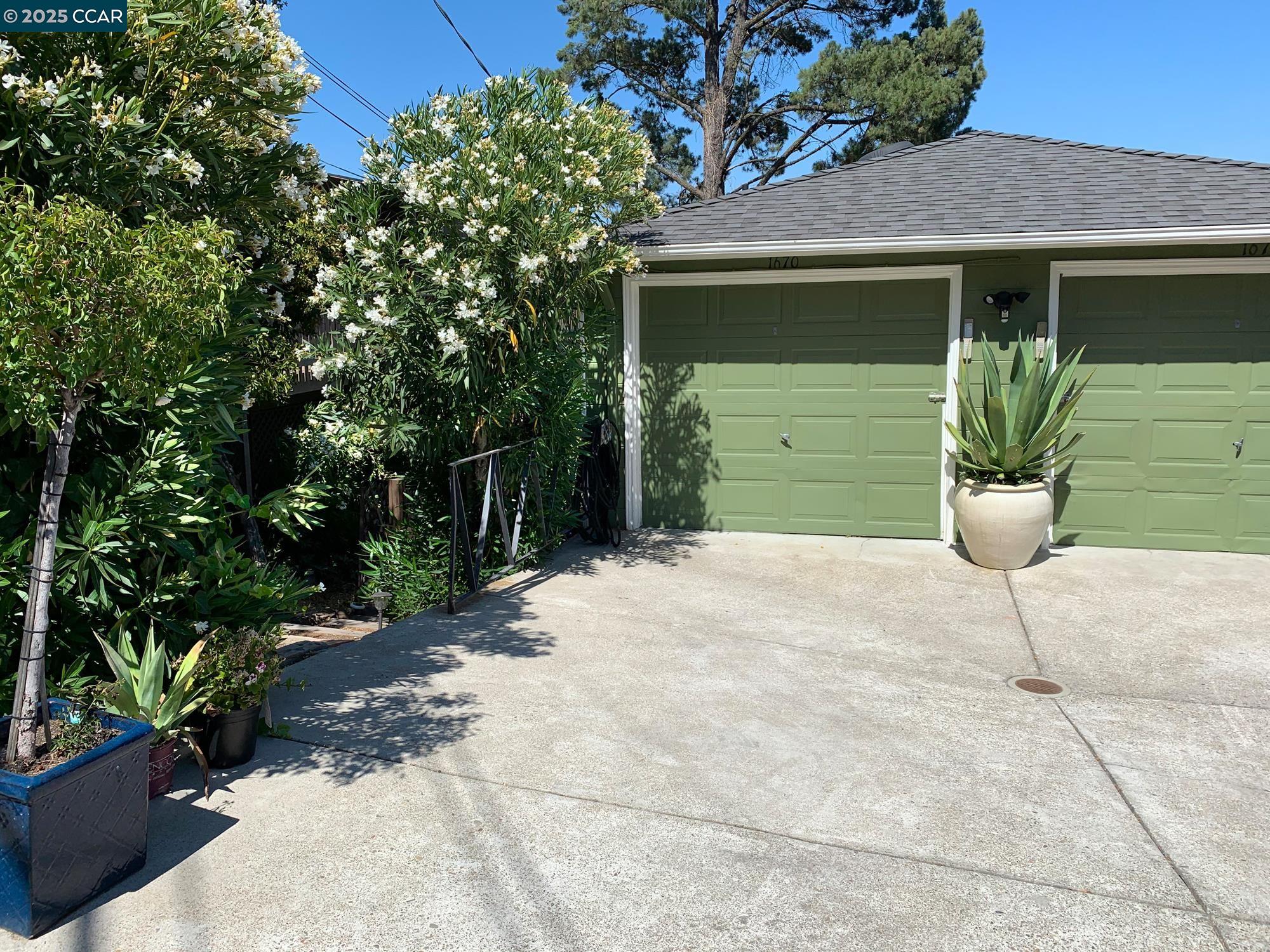 1672 Terrace Road Walnut Creek, CA 94597 - Photo 21 of 38 a front view of a house with a yard and garage