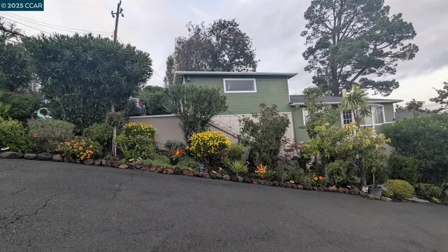 a view of a house with a flower garden