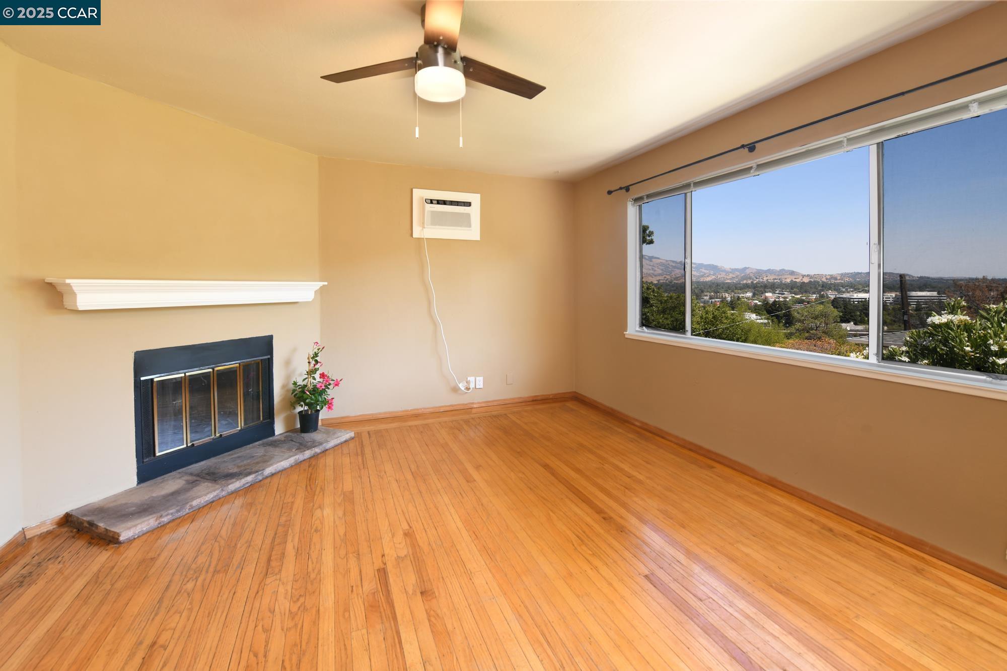 1672 Terrace Road Walnut Creek, CA 94597 - Photo 6 of 38 a view of empty room with wooden floor and fireplace