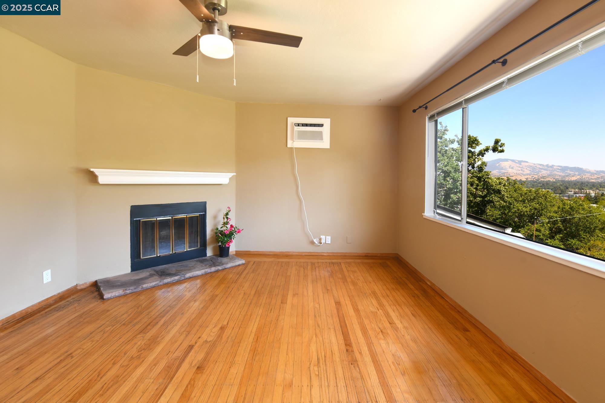 1672 Terrace Road Walnut Creek, CA 94597 - Photo 8 of 38 a view of empty room with wooden floor and fireplace