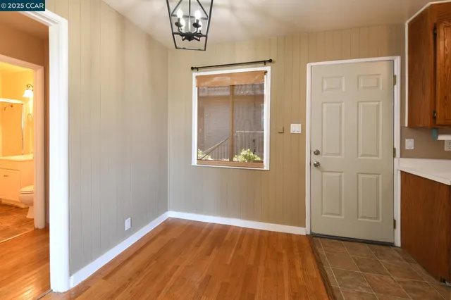 a view of a room with wooden floor