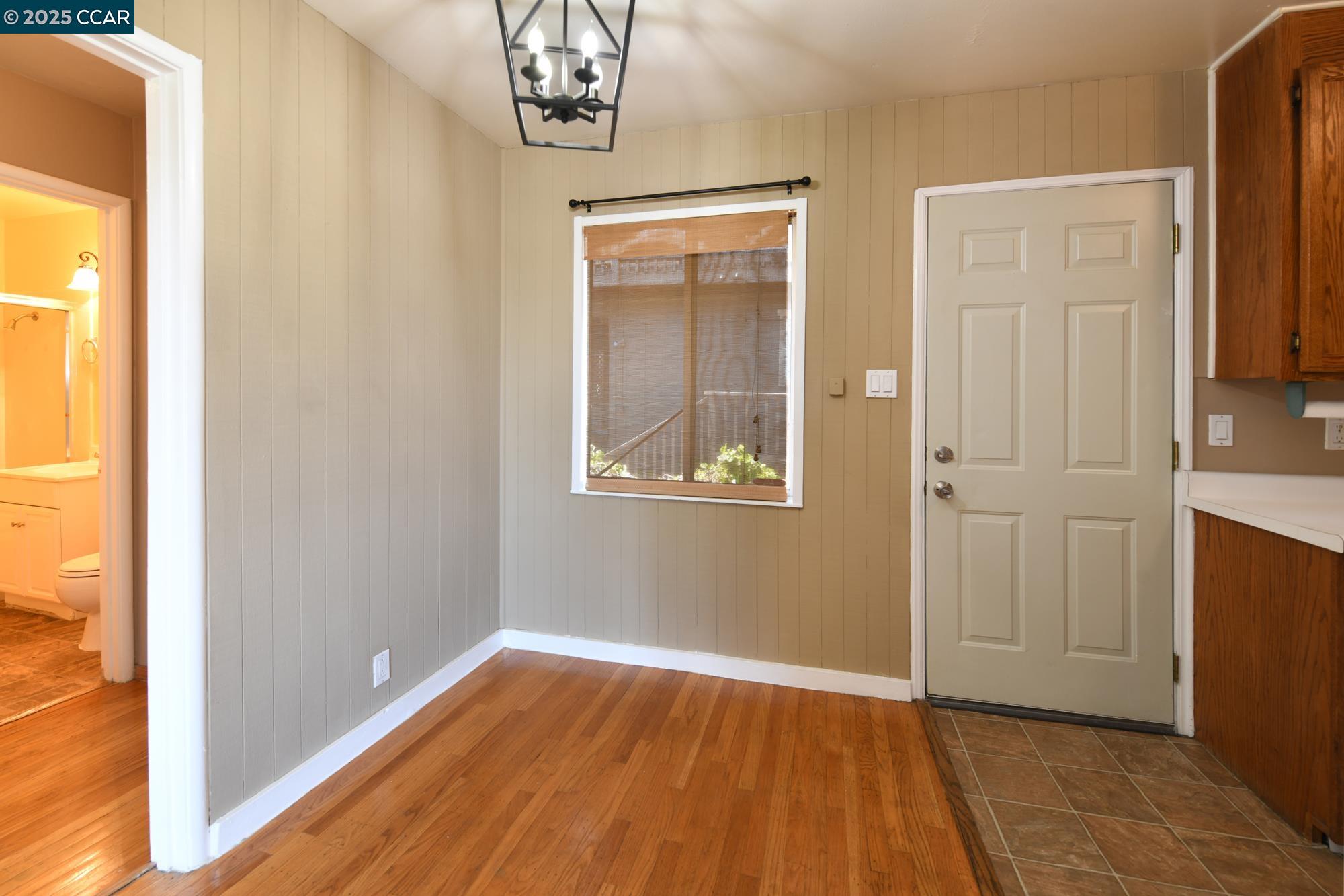 1672 Terrace Road Walnut Creek, CA 94597 - Photo 9 of 38 a view of an empty room with wooden floor