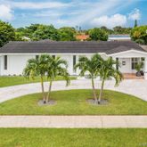 a house with swimming pool in front of it
