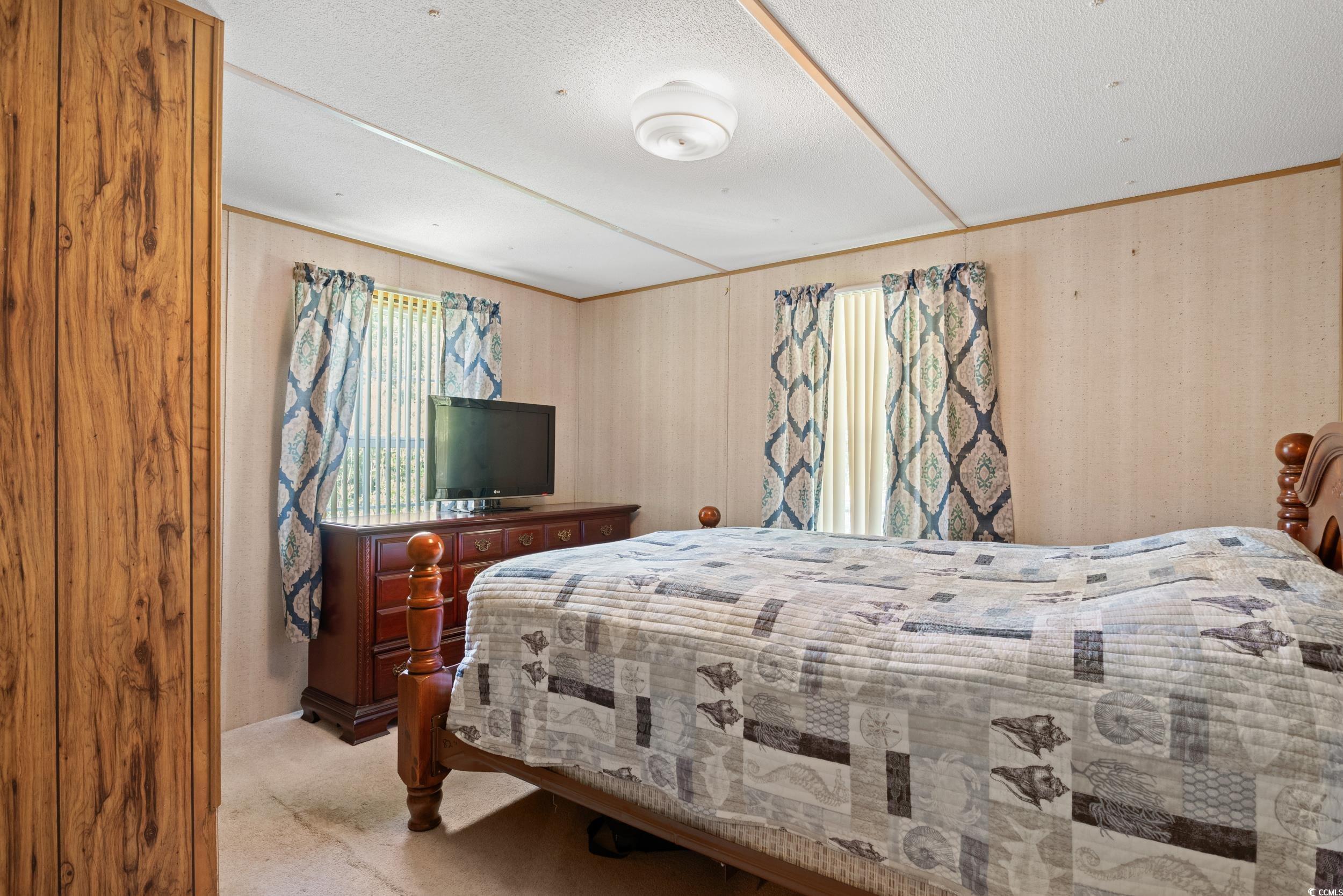 563 Plum Court Myrtle Beach, SC 29579 - Photo 4 of 34 Bedroom featuring carpet floors and a textured ceiling