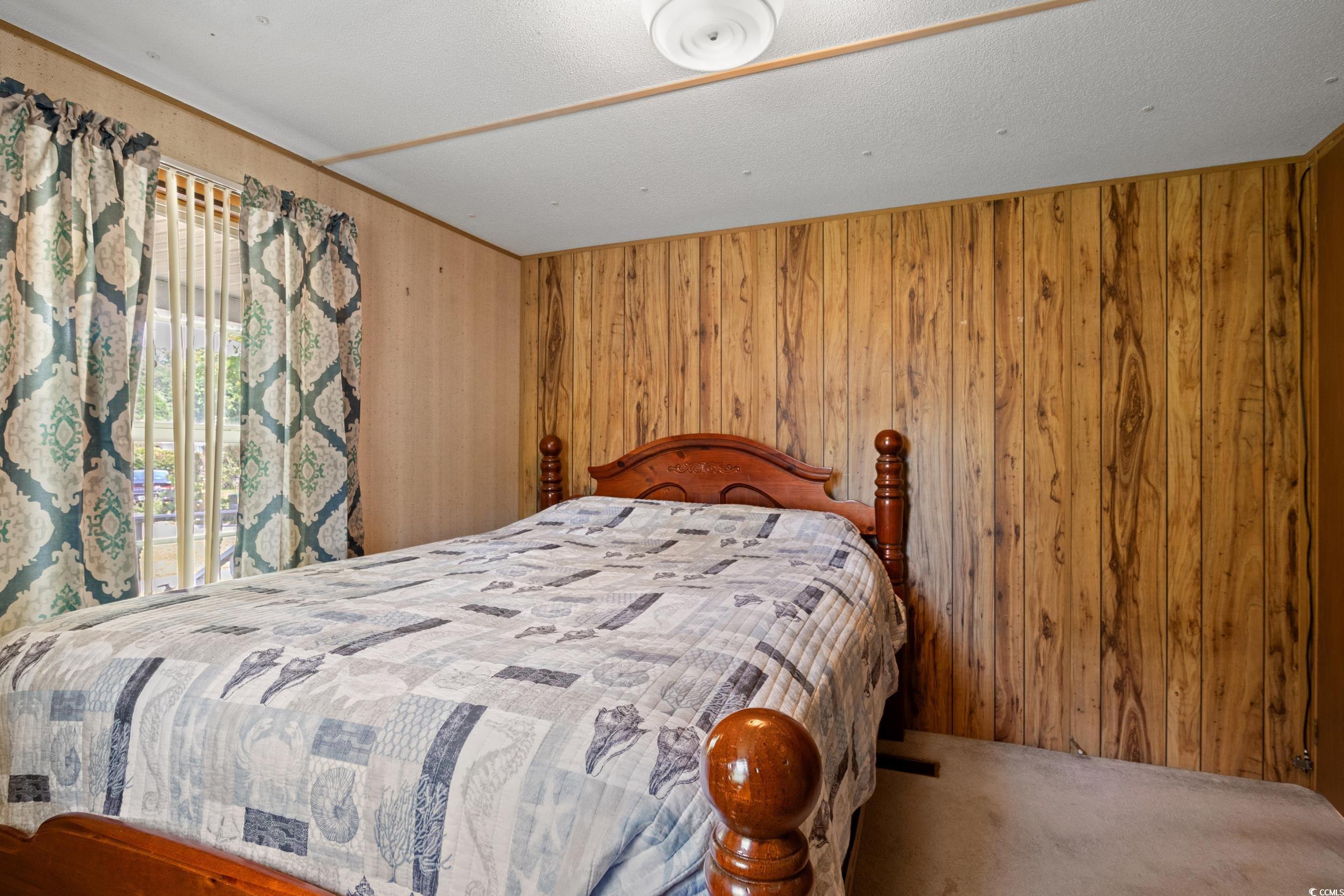 563 Plum Court Myrtle Beach, SC 29579 - Photo 5 of 34 Bedroom featuring wooden walls and carpet flooring