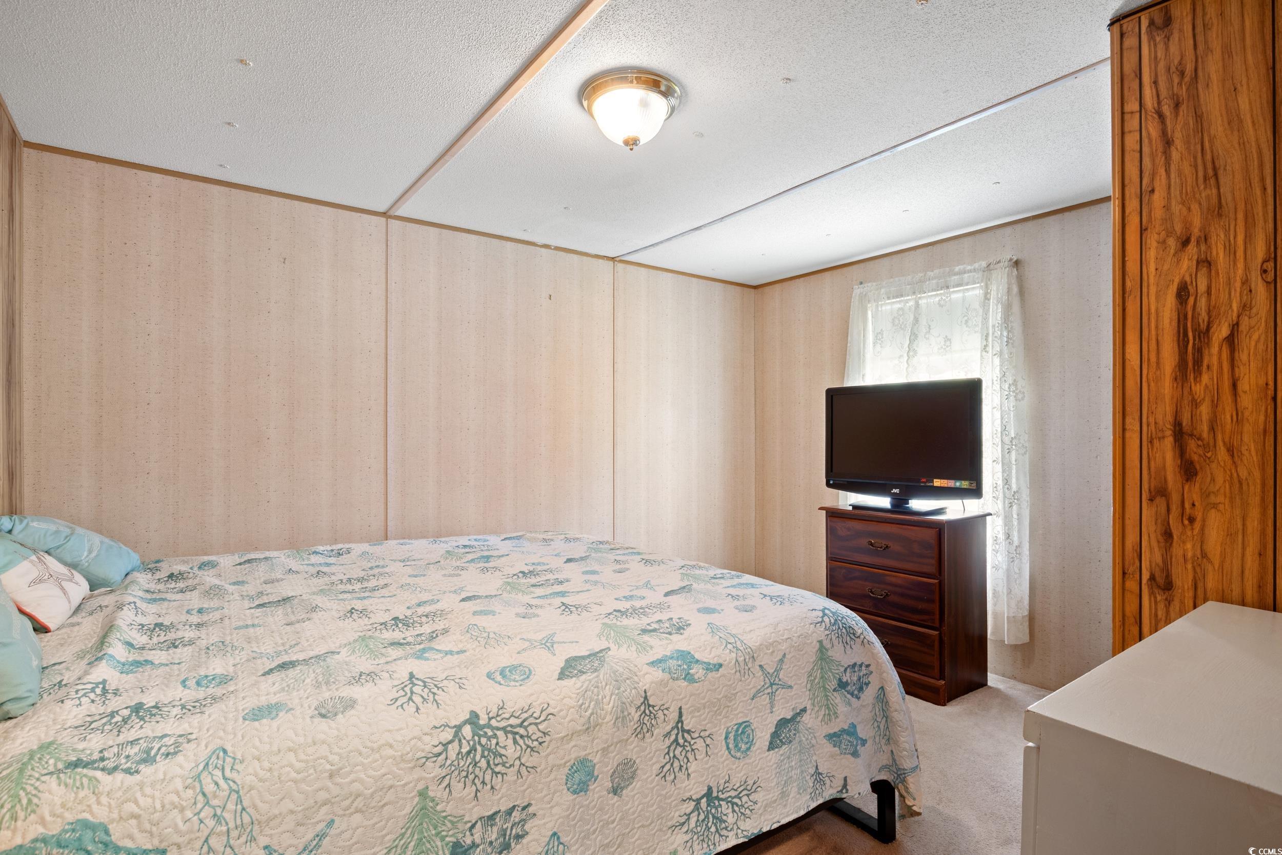 563 Plum Court Myrtle Beach, SC 29579 - Photo 8 of 34 Bedroom featuring carpet and wooden walls