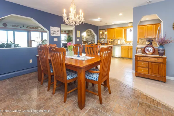 a view of a dining room with furniture and chandelier