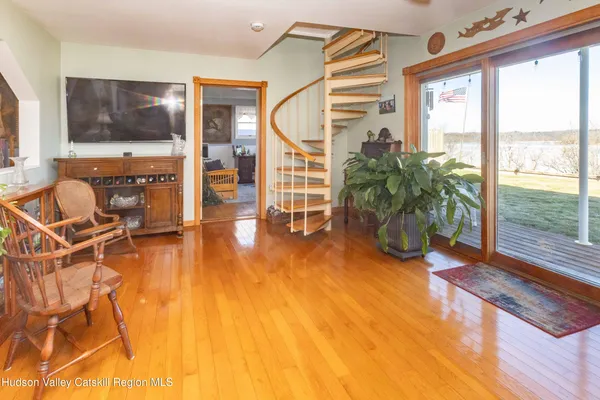 a living room with furniture and a flat screen tv with wooden floor