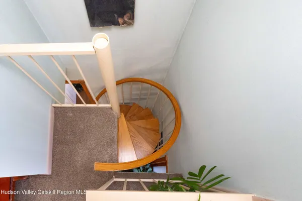a view of staircase with railing and a potted plant