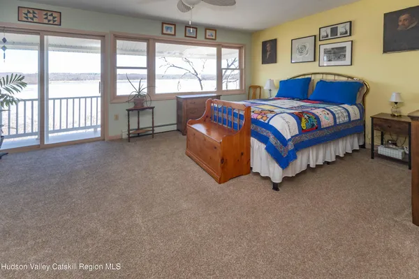 a spacious bedroom with a bed and a large window