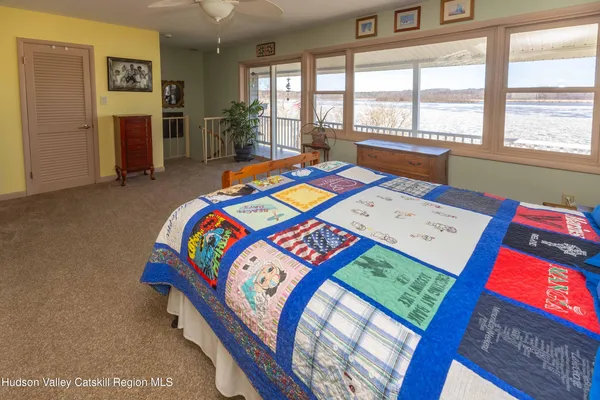 a bedroom with a bed and a large window