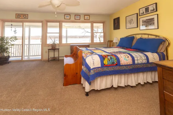 a bedroom with a bed and a large window