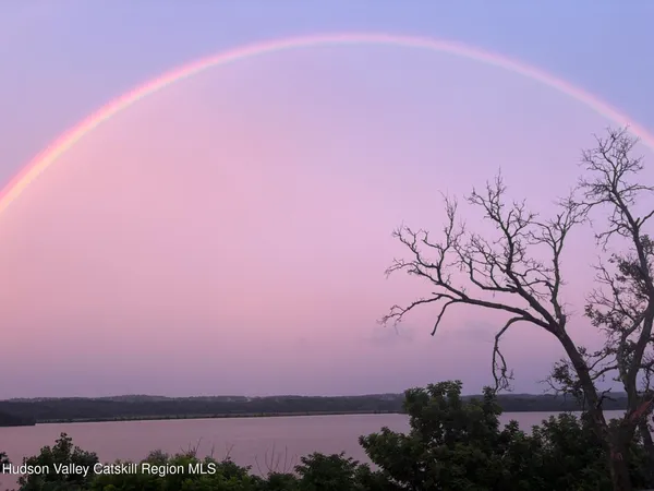 a view of residential houses with outdoor space and street view