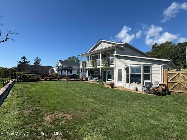 a view of a house with backyard porch and sitting area