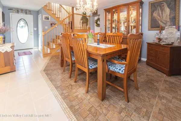 a dining room with furniture and a window