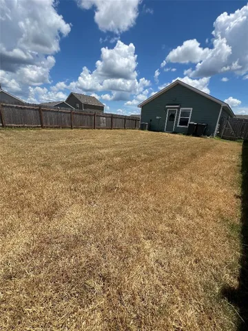 a kitchen with a sink dishwasher a stove and a refrigerator with wooden floor