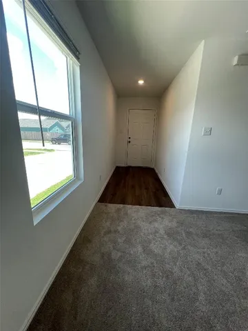 a view of an empty room with windows
