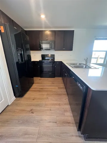 a kitchen with a sink and a large mirror
