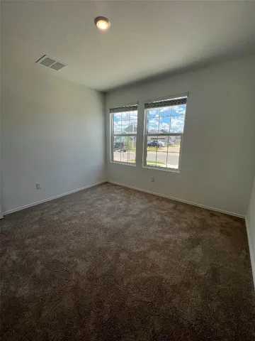 an empty room with a empty space and windows