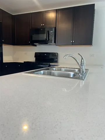 a close view of sink and cabinets