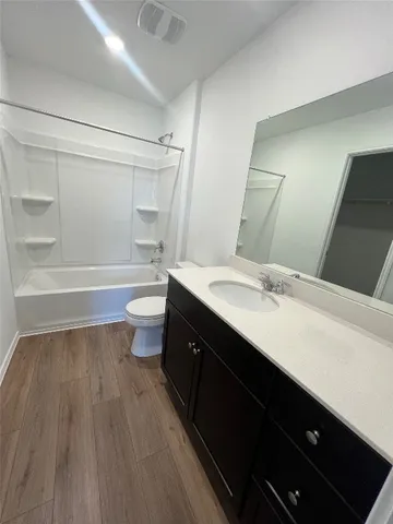 a bathroom with a double vanity sink toilet and shower