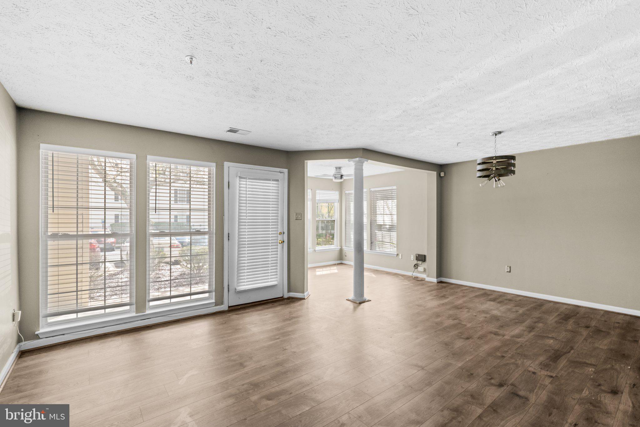4840 Shellbark Road, Unit 4840 Owings Mills, MD 21117 - Photo 7 of 47 wooden floor in an empty room with a window
