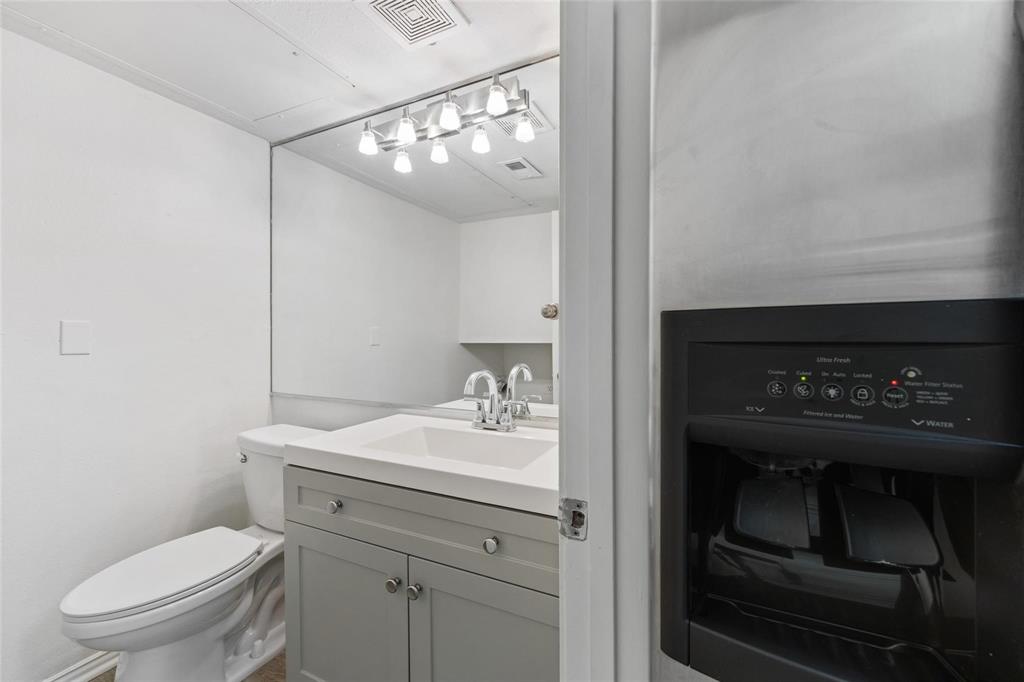 18240 Midway Road, Unit 402 Dallas, TX 75287 - Photo 11 of 29 Bathroom featuring a single vanity with gray cabinetry, a white countertop, and a chrome faucet