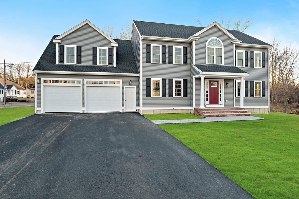a front view of a house with a yard and garage