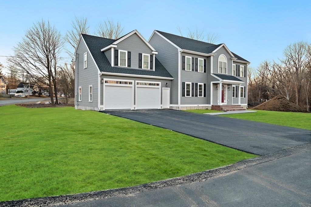 2 Pelissier Circle Randolph, MA 02368 - Photo 2 of 29 a front view of a house with a garden and trees
