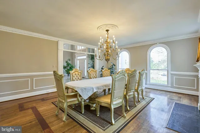 a living room with furniture a table and wooden floor