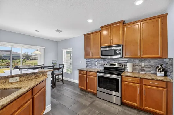 a kitchen with granite countertop a sink and a wooden cabinets