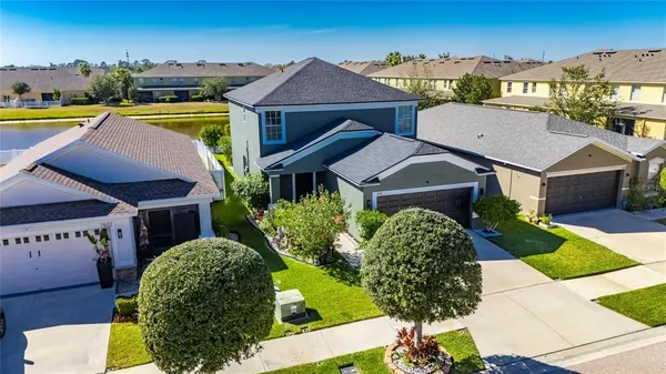 a aerial view of a house with swimming pool and a yard