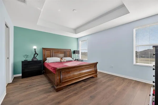a bathroom with a granite countertop bathtub a double vanity sink a vanity and a large mirror