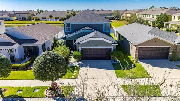 an aerial view of a house with a yard basket ball court and outdoor seating