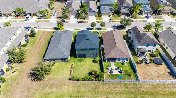 an aerial view of a house with outdoor seating