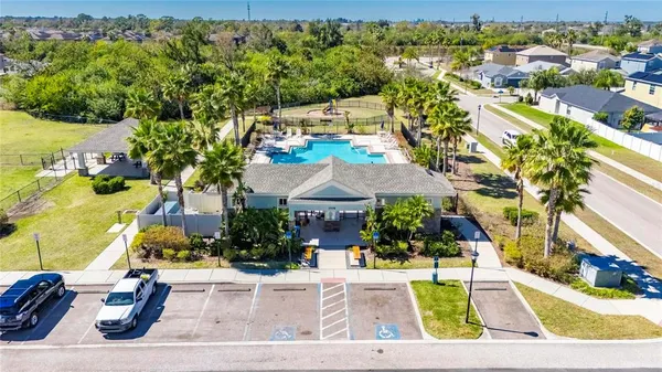 an aerial view of a house with a garden and lake view