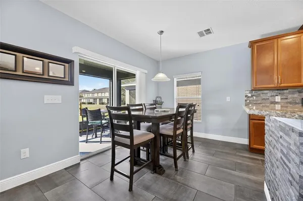 a kitchen with stainless steel appliances granite countertop a stove top oven a sink dishwasher and a refrigerator with wooden floor