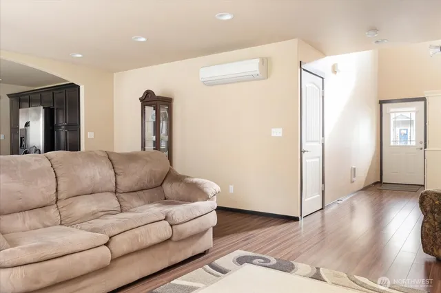 a living room with furniture and wooden floor