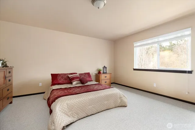 a bedroom with a bed and window